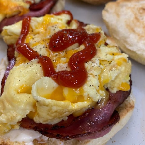 Plainview Bagel Cafe's bagel with scrambled eggs, cheese, bacon, and ketchup.